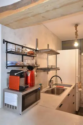 a kitchen with a microwave and a sink at Studio Mavili in Athens