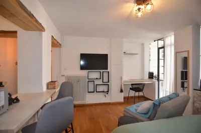 a living room with a couch and chairs and a tv at Studio Mavili in Athens