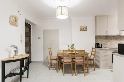a kitchen and dining room with a table and chairs at Plaka's Hyatt in Athens