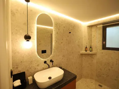a bathroom with a sink and a mirror at Becool Apartment in Porto Rafti