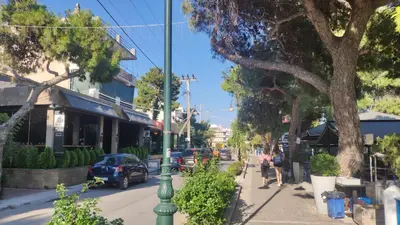 a street with a green pole on the side of the road at Luxurious apartment close to the beach and airport in Porto Rafti