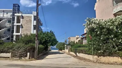 an empty street in an alley between buildings at Luxurious apartment close to the beach and airport in Porto Rafti