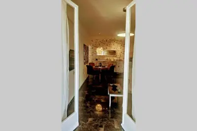a hallway with a table and a dining room at Luxurious apartment close to the beach and airport in Porto Rafti
