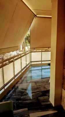 a swimming pool on a balcony of a building at Luxurious apartment close to the beach and airport in Porto Rafti