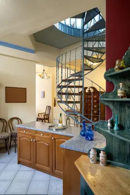 a kitchen with a spiral staircase in a room at ViLLA127 in Athens