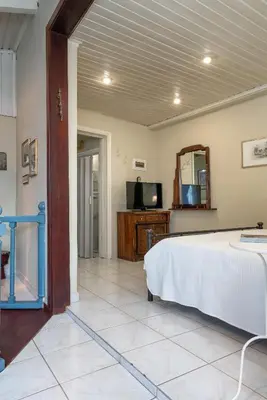 a bedroom with a bed and a mirror and a tv at ViLLA127 in Athens