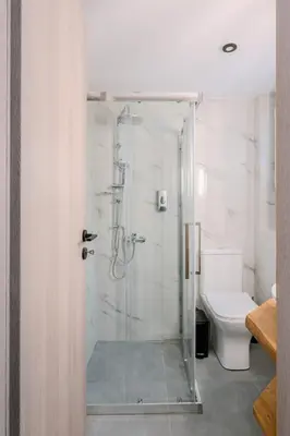 a bathroom with a shower and a toilet at Place to be Athens apartment in Athens