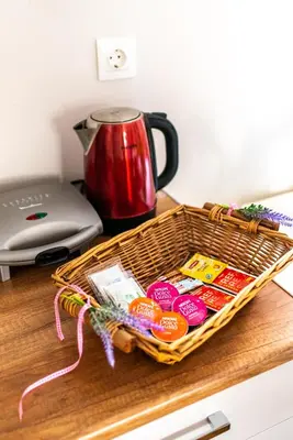 a basket of food on a table with a tea pot at Place to be Athens apartment in Athens