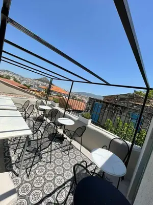 a group of tables and chairs on a balcony at Acron Athens in Athens