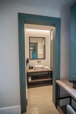 a bathroom with a sink and a mirror at Acron Athens in Athens