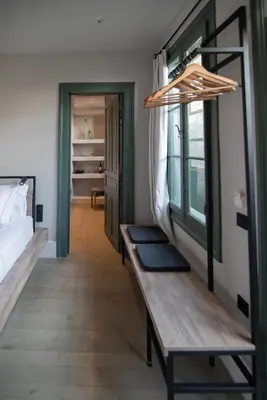 a room with a bed and a wooden bench at Acron Athens in Athens