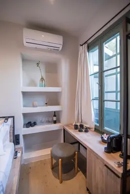 a bedroom with a desk and a chair and a window at Acron Athens in Athens