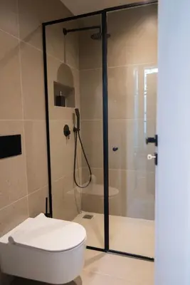 a bathroom with a toilet and a glass shower at Acron Athens in Athens