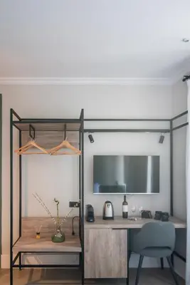 a room with a desk and a table with a chair at Acron Athens in Athens