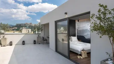 a bedroom with a bed on a balcony at Ivis 4 Boutique Hotel in Athens