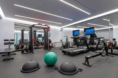 a gym with a fitness room with machines and a green ball at Ivis 4 Boutique Hotel in Athens