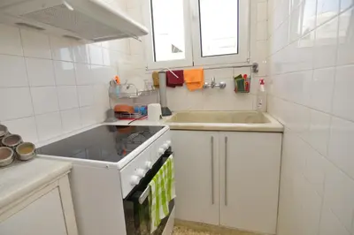 a white kitchen with a sink and a stove at Athens Stylish top floor apartment Syntagma metro in Athens