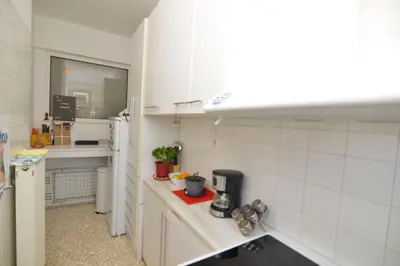 a small kitchen with white walls and white appliances at Athens Stylish top floor apartment Syntagma metro in Athens