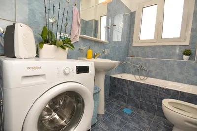a washing machine in a bathroom with a toilet and a sink at Athens Stylish top floor apartment Syntagma metro in Athens