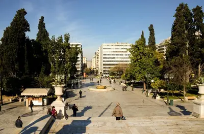 a group of people walking around a plaza with a fountain at Athens Stylish top floor apartment Syntagma metro in Athens