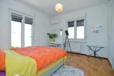 a bedroom with a bed and a desk and windows at Athens Stylish top floor apartment Syntagma metro in Athens