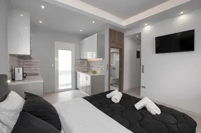 a bedroom with a large black bed with white pillows at Studio penthouse near Acropolis Museum by GHH in Athens