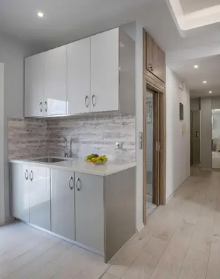 a kitchen with white cabinets and a sink at Studio penthouse near Acropolis Museum by GHH in Athens