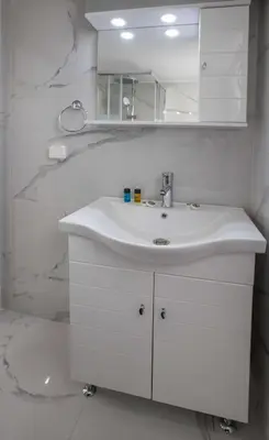 a white bathroom with a sink and a mirror at Studio penthouse near Acropolis Museum by GHH in Athens