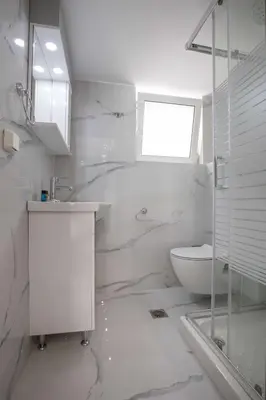 a white bathroom with a sink and a toilet at Studio penthouse near Acropolis Museum by GHH in Athens