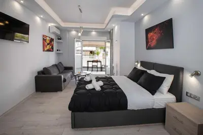 a bedroom with a large bed and a couch at Studio penthouse near Acropolis Museum by GHH in Athens