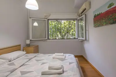 a bedroom with a large bed and a window at Stylish apt in the Historic heart of the city in Athens