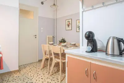 a kitchen with a table and chairs in a room at Stylish apt in the Historic heart of the city in Athens