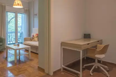 a room with a desk and a chair and a couch at Stylish apt in the Historic heart of the city in Athens