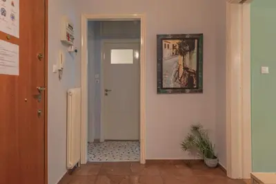 a hallway with a door and a painting on the wall at Stylish apt in the Historic heart of the city in Athens