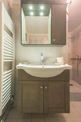a bathroom with a sink and a mirror at Stylish apt in the Historic heart of the city in Athens