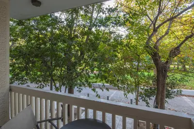 a balcony with a table and chairs and trees at Stylish apt in the Historic heart of the city in Athens