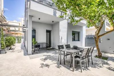 an outdoor patio with a table and chairs at Spacious flat with courtyard in Peristeri! in Athens