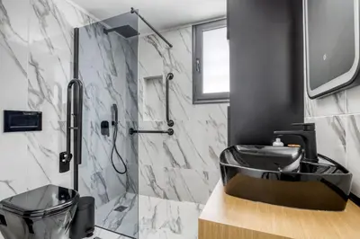a bathroom with a sink and a shower at Spacious flat with courtyard in Peristeri! in Athens