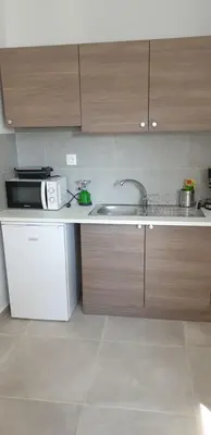a kitchen with a sink and a microwave at AVR Airport Deluxe Suites 6 AIRPORT FREE SHUTLE in Markopoulo