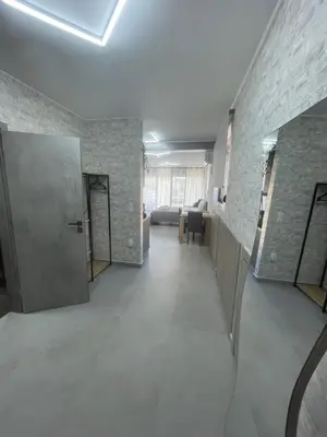 a room with a hallway with a door and a brick wall at AVR Airport Deluxe Suites 6 AIRPORT FREE SHUTLE in Markopoulo