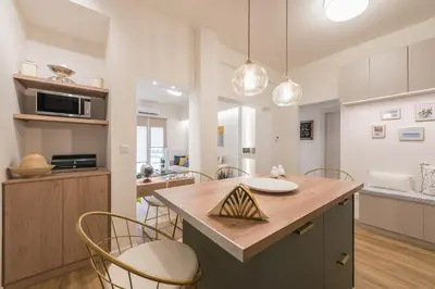 a kitchen with a table and chairs in a kitchen at Chic and Comfort Home in Central Athens in Athens