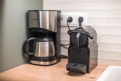 affeepot and coffee maker sitting on a counter at Chic and Comfort Home in Central Athens in Athens