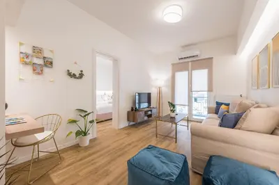 a living room with a couch and a table at Chic and Comfort Home in Central Athens in Athens