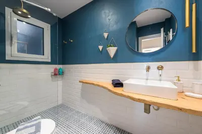 a bathroom with a sink and a mirror at Chic and Comfort Home in Central Athens in Athens