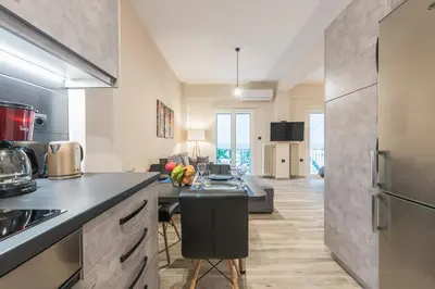 a kitchen with a counter and a table in a room at Modern apartment Downtown Athens in Athens