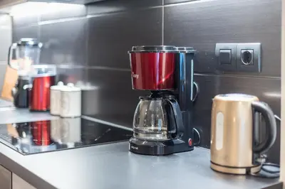 a red blender sitting on a counter in a kitchen at Modern apartment Downtown Athens in Athens
