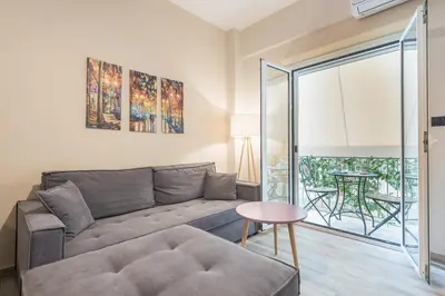 a living room with a couch and a table at Modern apartment Downtown Athens in Athens