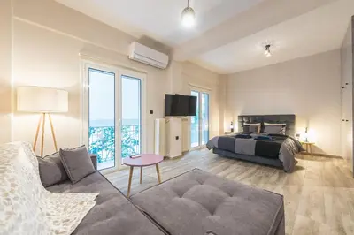 a living room with a bed and a couch at Modern apartment Downtown Athens in Athens