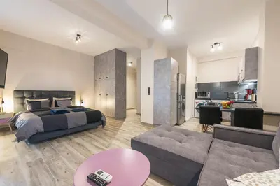 a bedroom with a bed and a living room at Modern apartment Downtown Athens in Athens