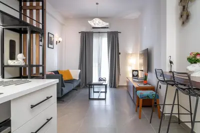 a kitchen and living room with a couch and a table at Glyfada Gallery Apartment by First Class Properties in Athens